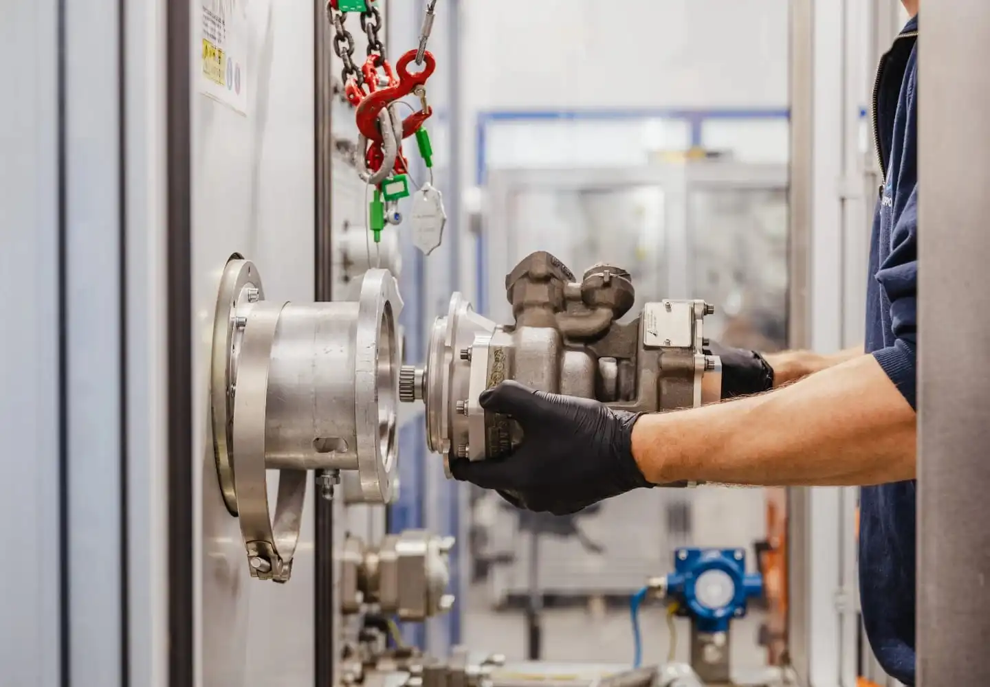 Technician installing an aircraft component on a testing system at Air Support